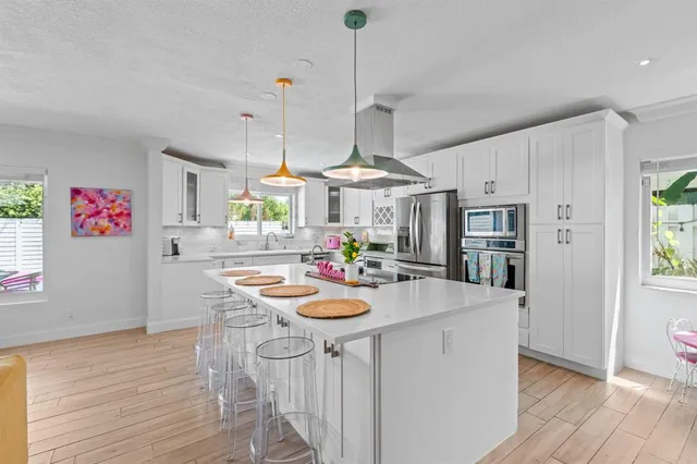 a kitchen with stainless steel appliances a sink stove and refrigerator