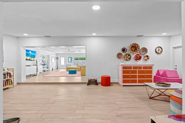 a living room with furniture and a baby crib