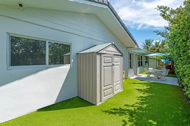 a kitchen with a sink cabinets and a window