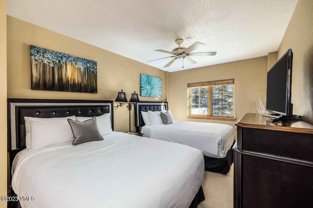 210 Offerson Road, Unit R225 Beaver Creek, CO 81620 - Photo 16 of 42 a bedroom with a bed and a flat screen tv