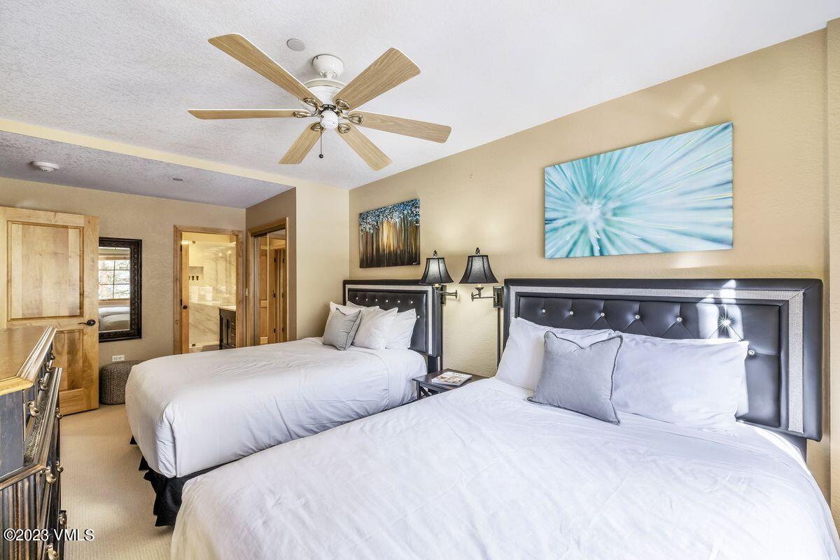 210 Offerson Road, Unit R225 Beaver Creek, CO 81620 - Photo 17 of 42 a bedroom with a large bed and a chandelier