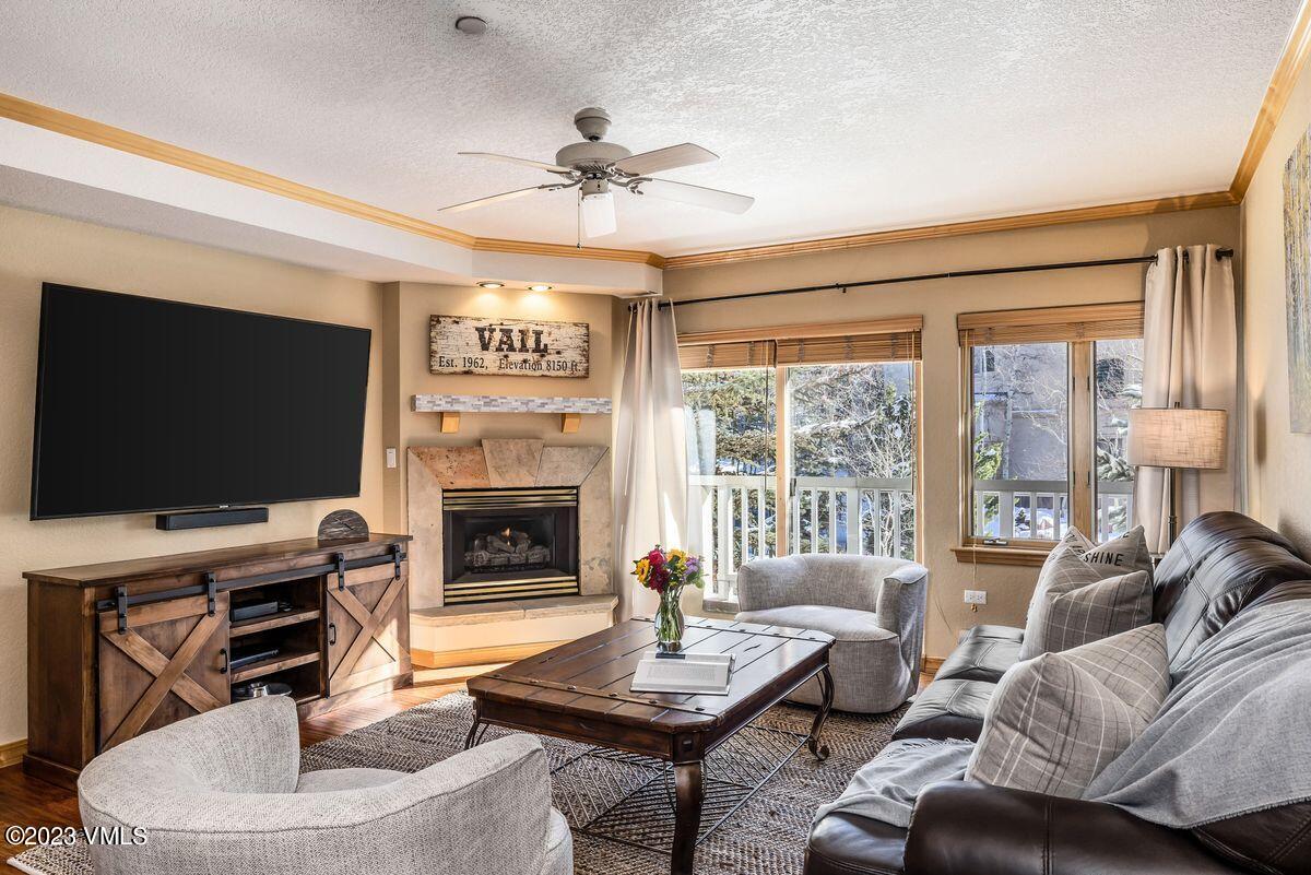 210 Offerson Road, Unit R225 Beaver Creek, CO 81620 - Photo 2 of 42 a living room with furniture a fireplace and a flat screen tv