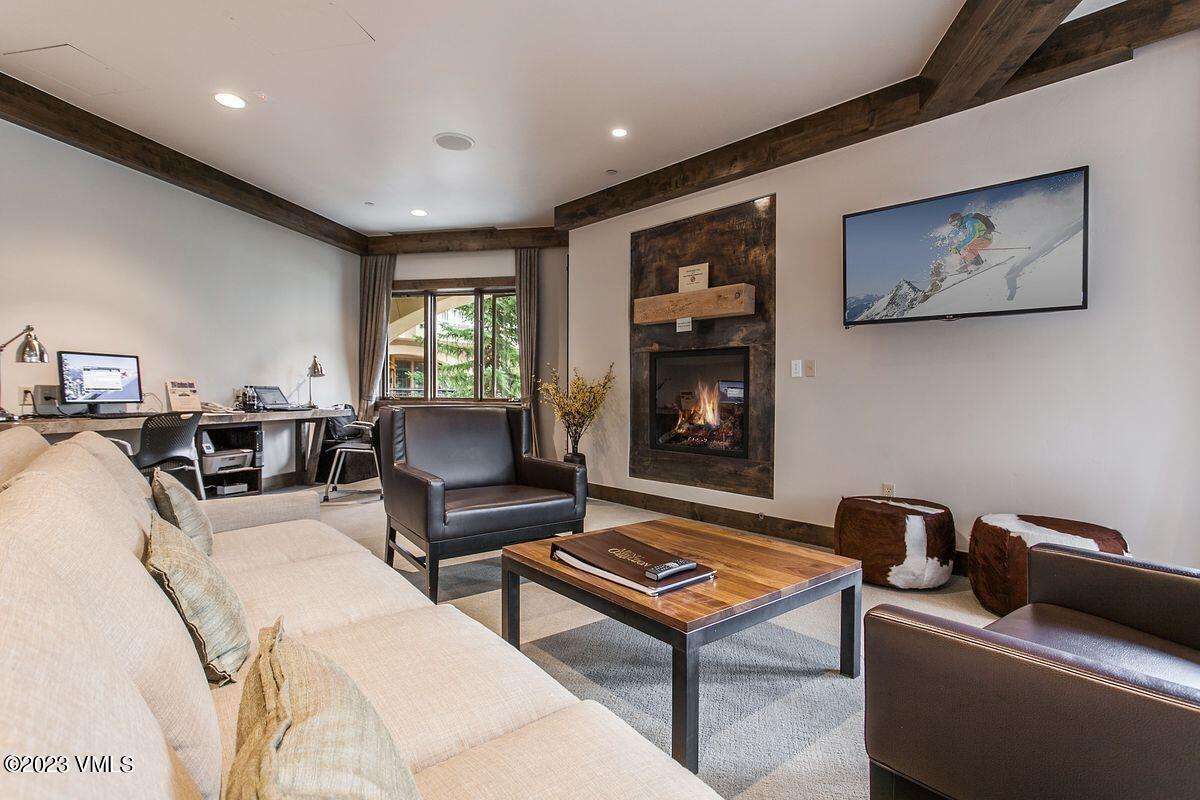 210 Offerson Road, Unit R225 Beaver Creek, CO 81620 - Photo 28 of 42 a living room with furniture a flat screen tv and a fireplace