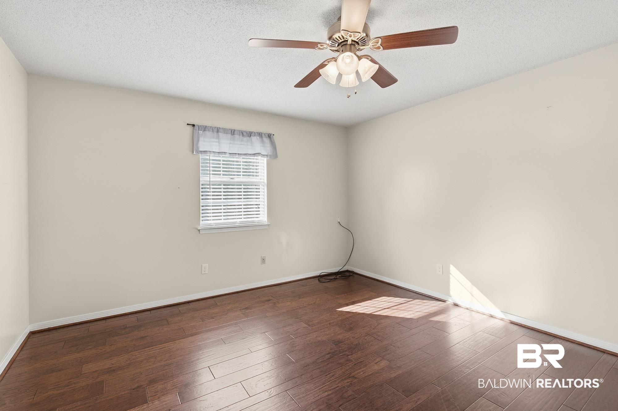 9215 Shiloh Drive Mobile, AL 36695 - Photo 21 of 32 Unfurnished room with a textured ceiling, dark wood-style floors, and ceiling fan