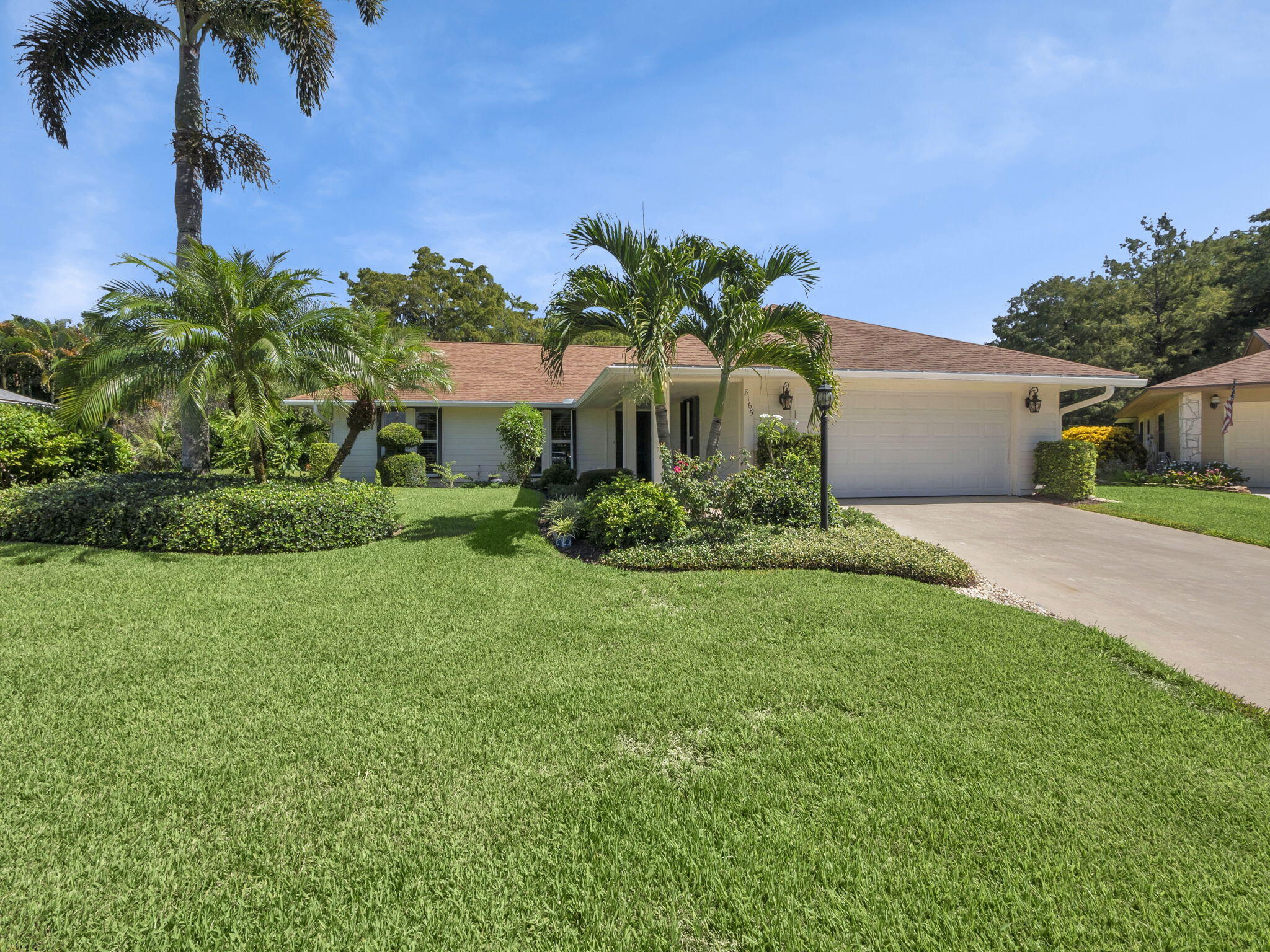 8165 Southeast Cypress Point Place Hobe Sound, FL 33455 - Photo 1 of 46 a front view of a house with garden