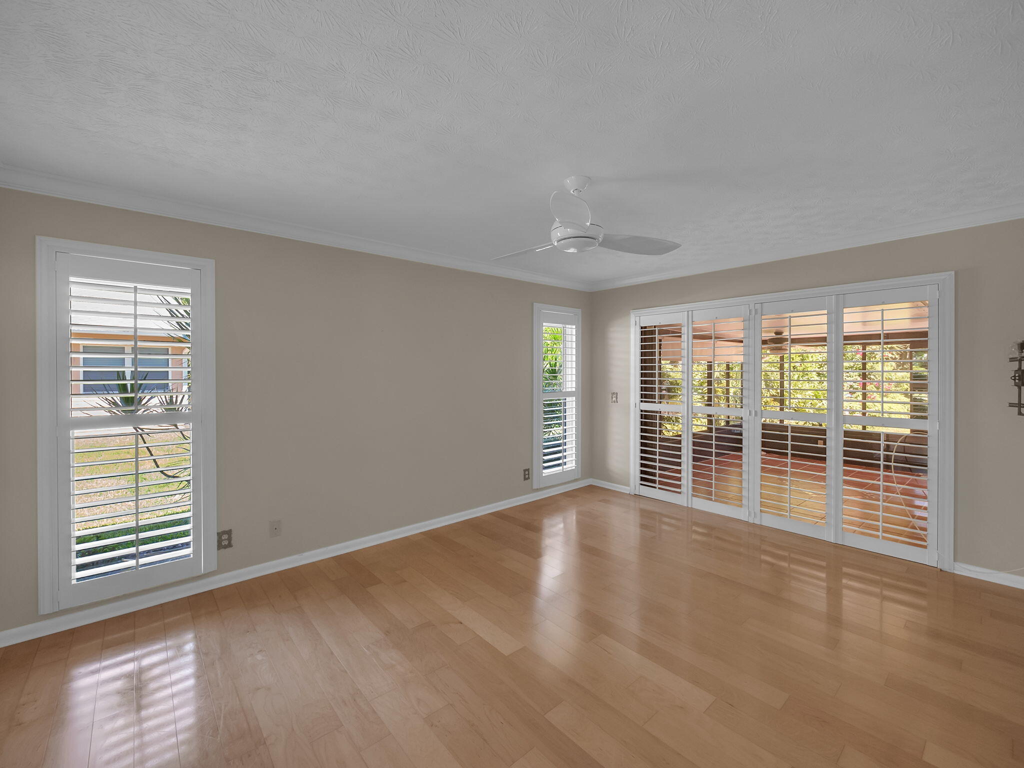 8165 Southeast Cypress Point Place Hobe Sound, FL 33455 - Photo 16 of 46 a view of an empty room with wooden floor and a window