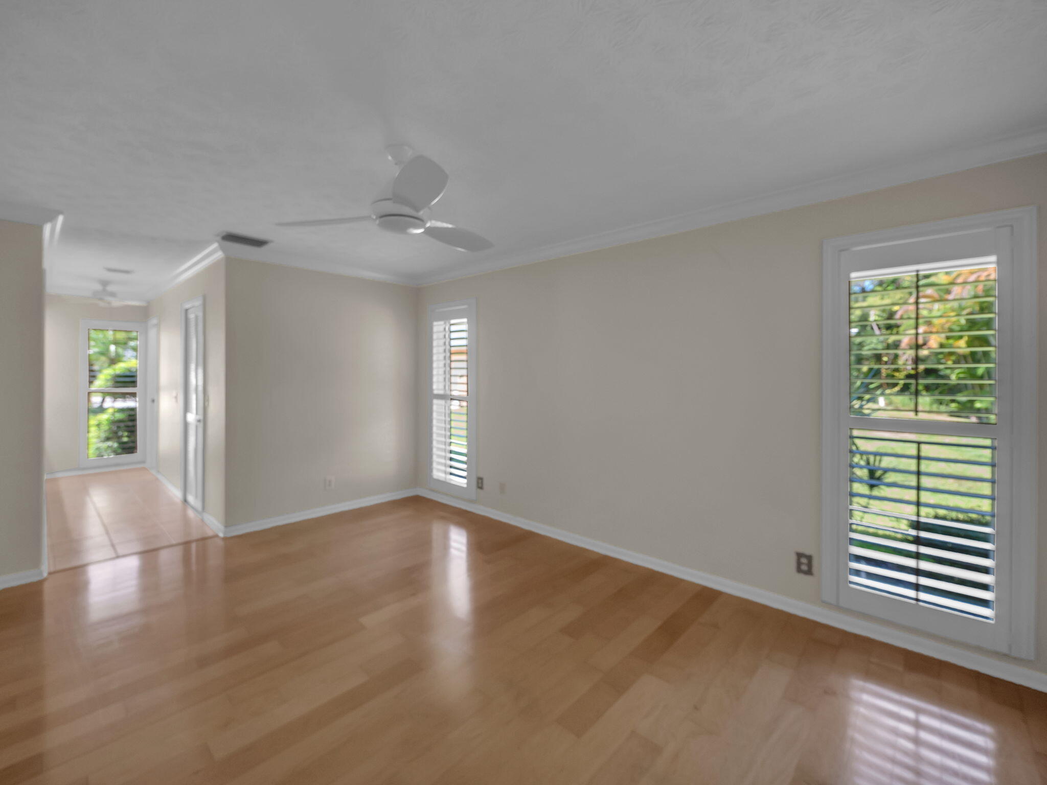 8165 Southeast Cypress Point Place Hobe Sound, FL 33455 - Photo 17 of 46 a view of an empty room with wooden floor and a window