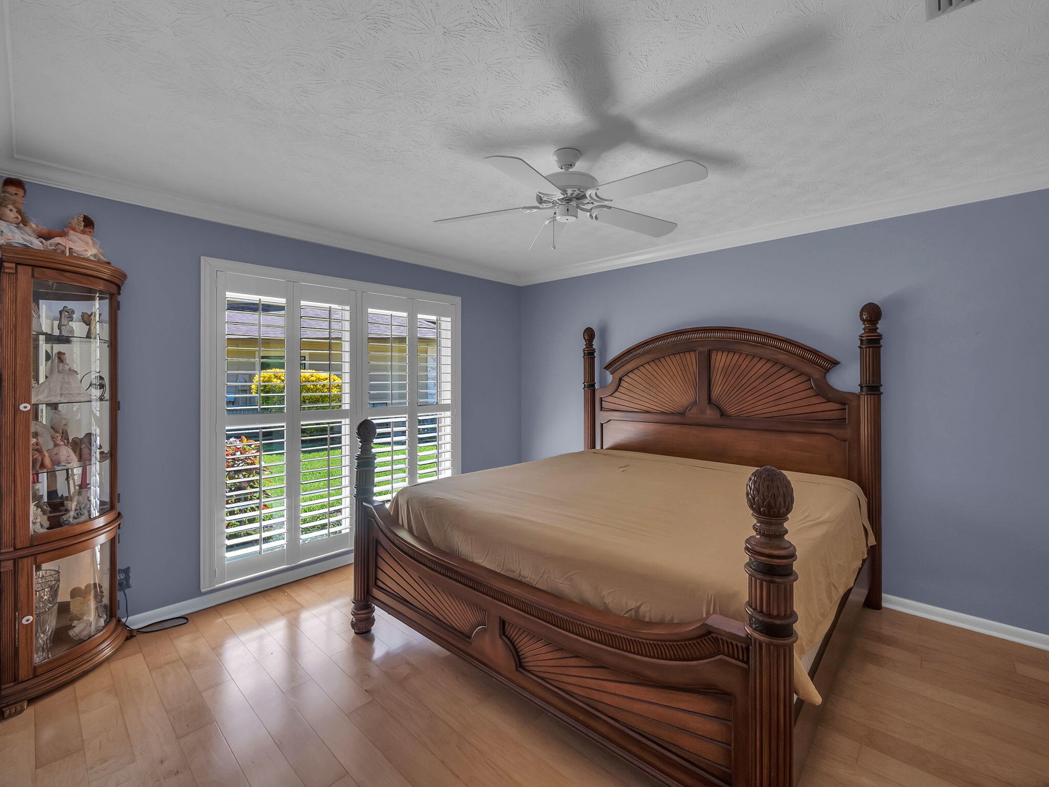 8165 Southeast Cypress Point Place Hobe Sound, FL 33455 - Photo 20 of 46 a bedroom with a bed a dresser and a large window