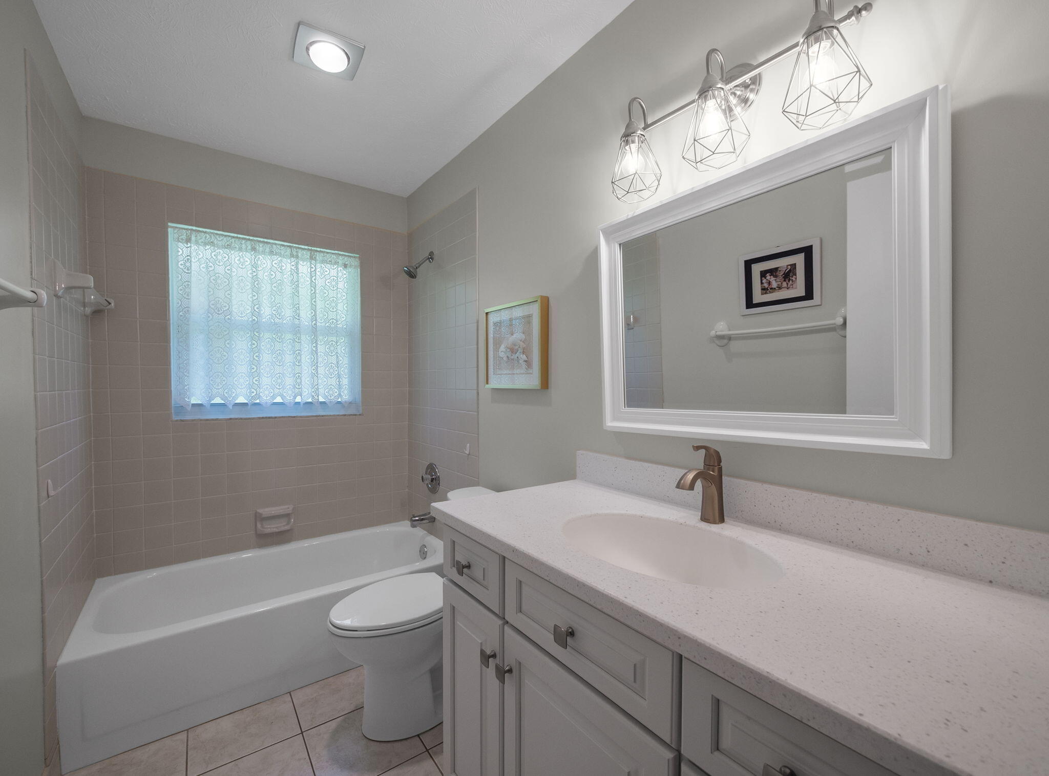 8165 Southeast Cypress Point Place Hobe Sound, FL 33455 - Photo 21 of 46 a bathroom with a toilet a sink a mirror and a window