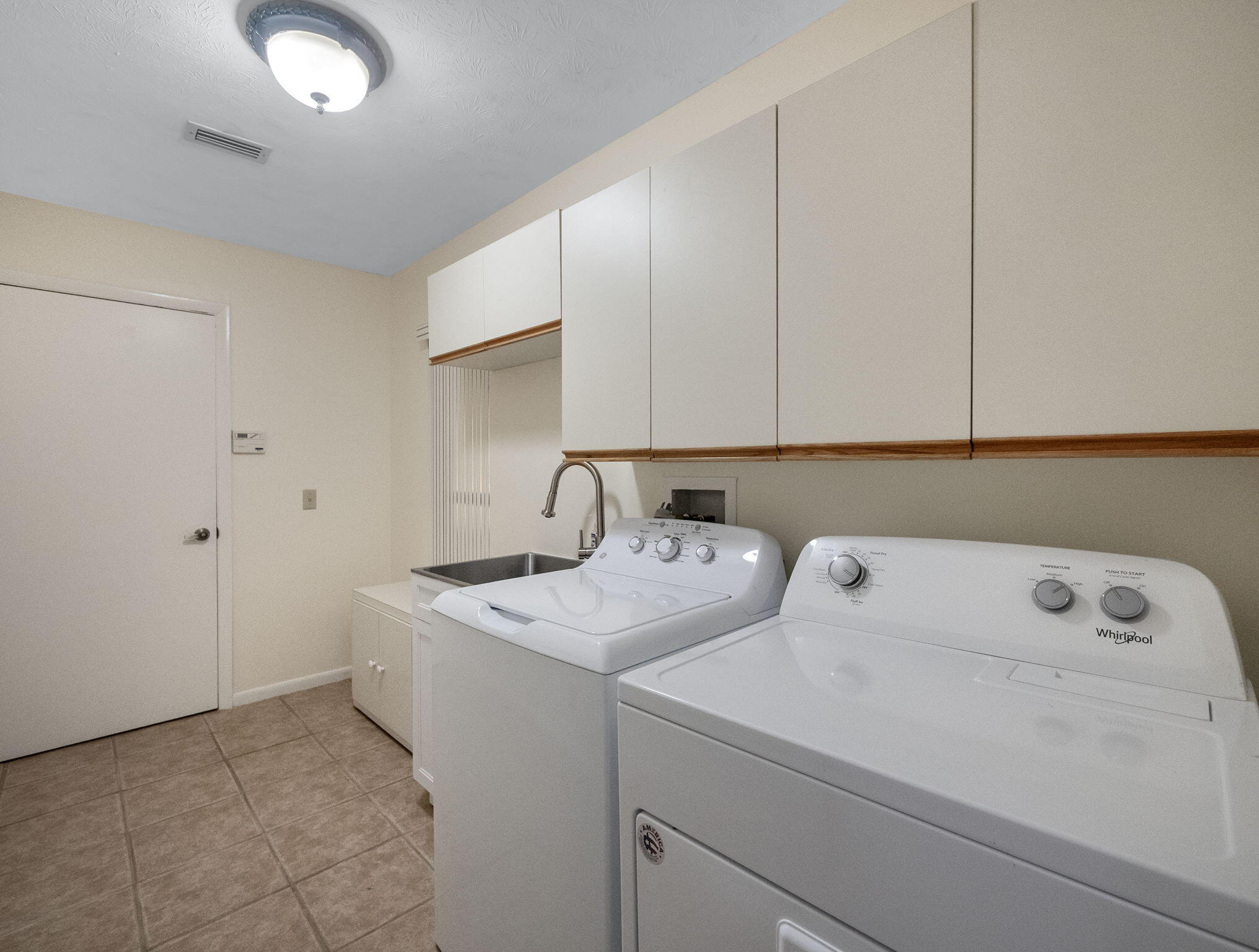 8165 Southeast Cypress Point Place Hobe Sound, FL 33455 - Photo 24 of 46 a utility room with dryer and washer