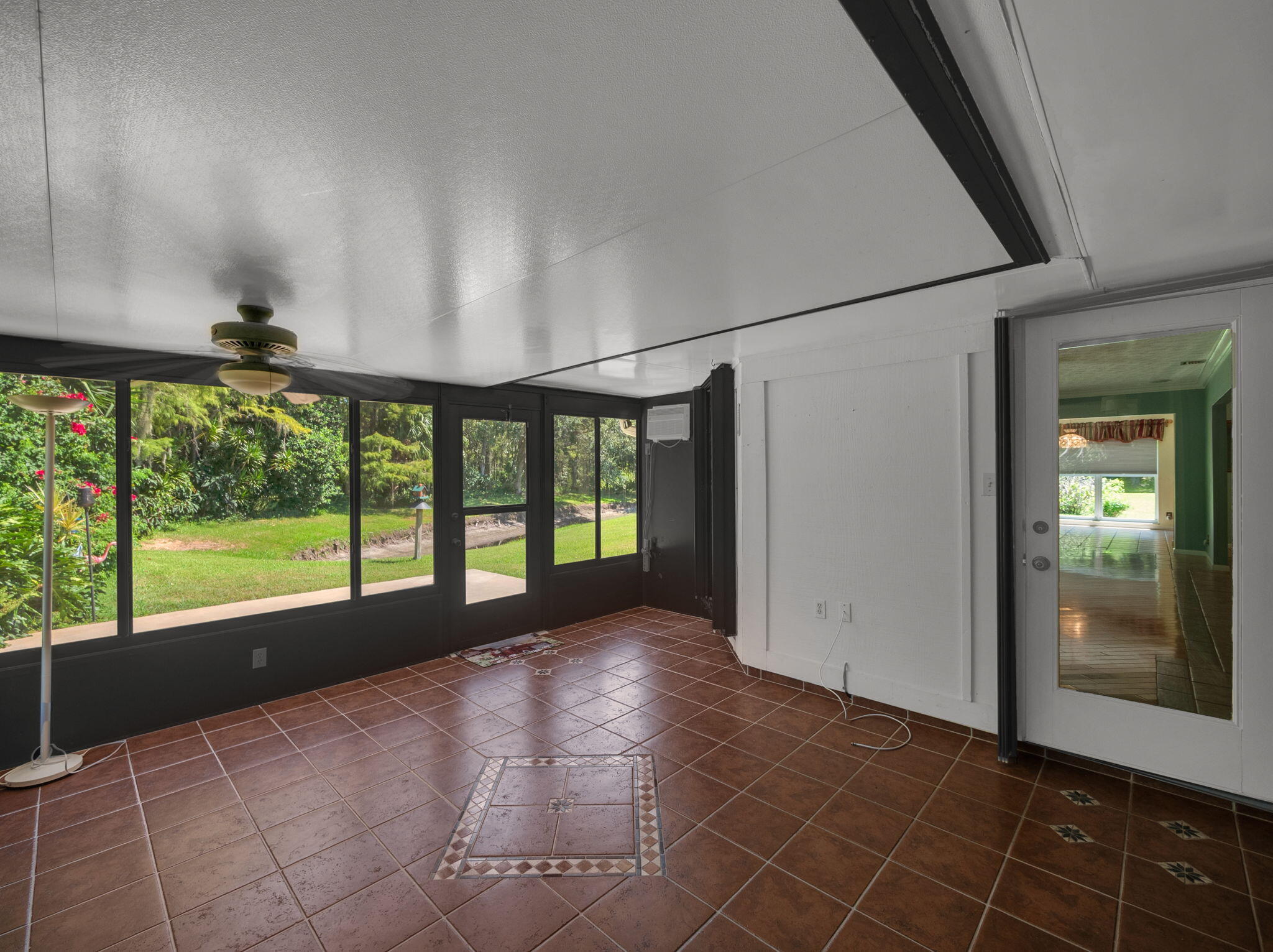 8165 Southeast Cypress Point Place Hobe Sound, FL 33455 - Photo 26 of 46 a view of an empty room with a fireplace and a large window