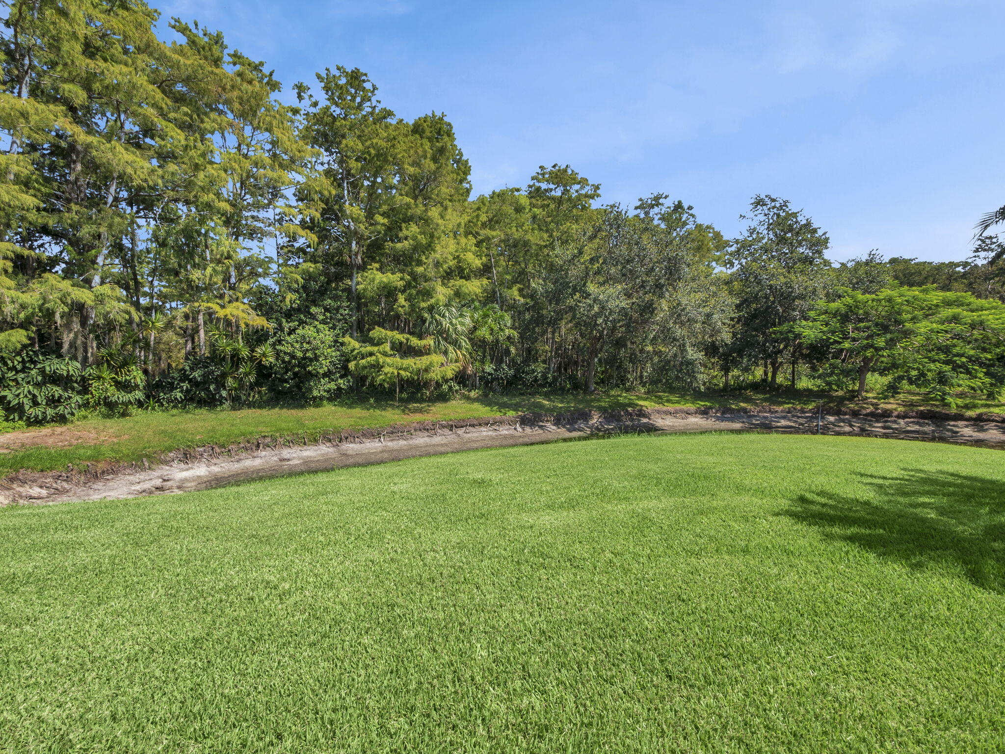 8165 Southeast Cypress Point Place Hobe Sound, FL 33455 - Photo 30 of 46 a view of a green field