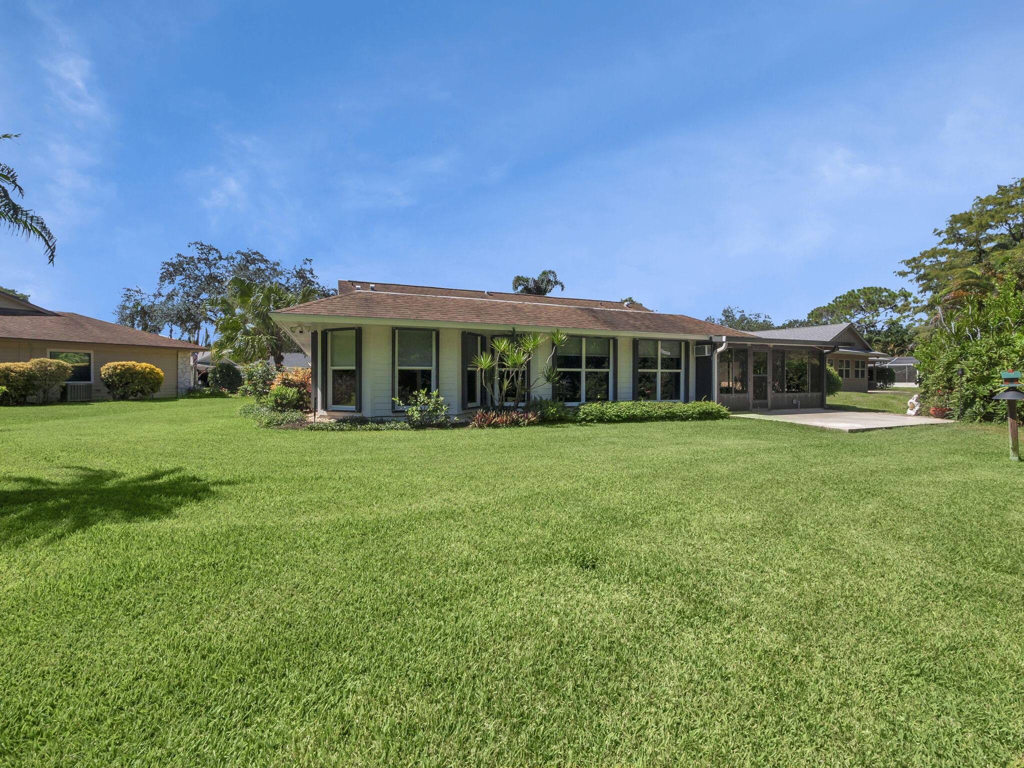 8165 Southeast Cypress Point Place Hobe Sound, FL 33455 - Photo 31 of 46 a view of a house with a yard