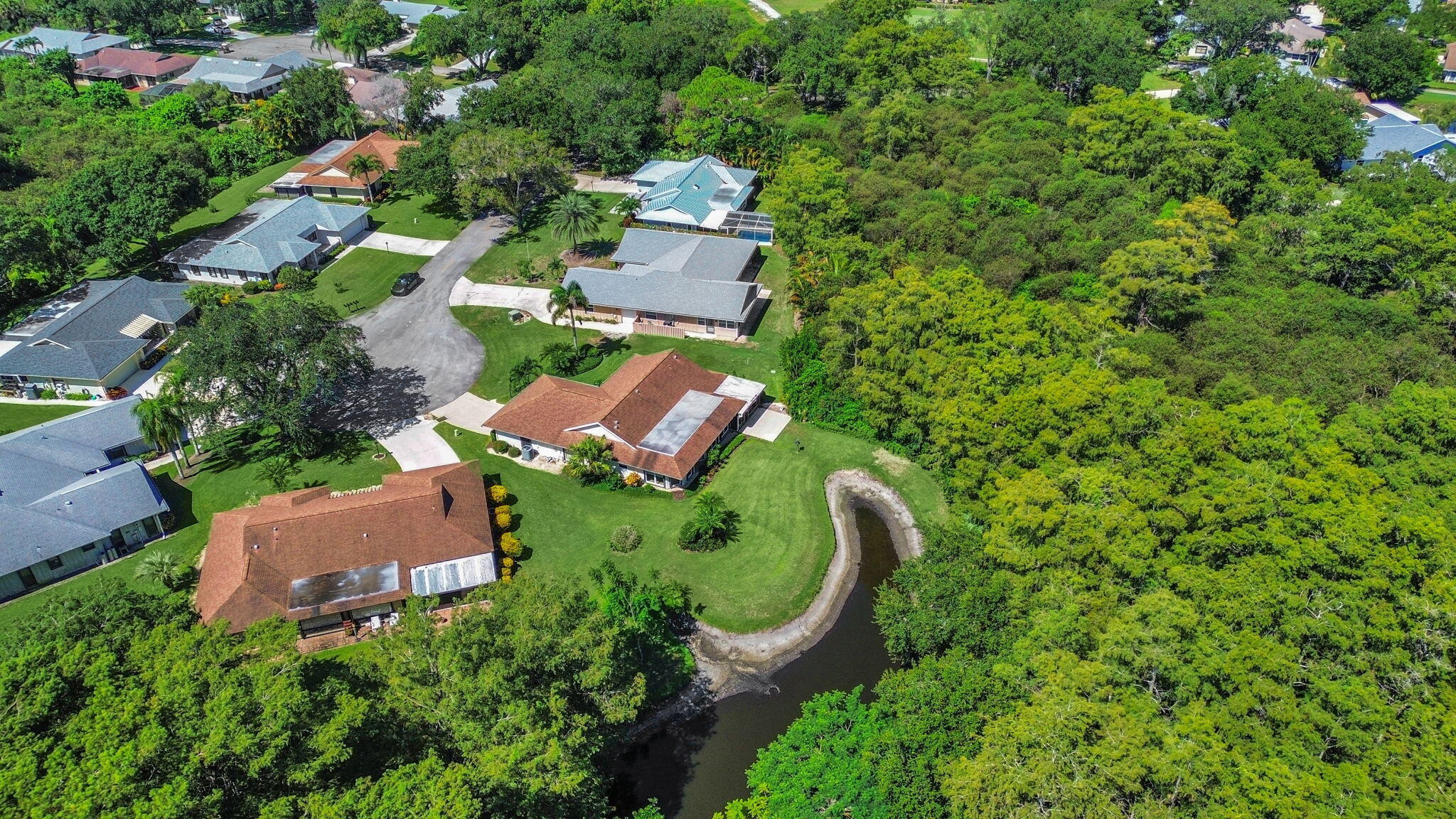 8165 Southeast Cypress Point Place Hobe Sound, FL 33455 - Photo 33 of 46 an aerial view of a house with a yard and outdoor seating