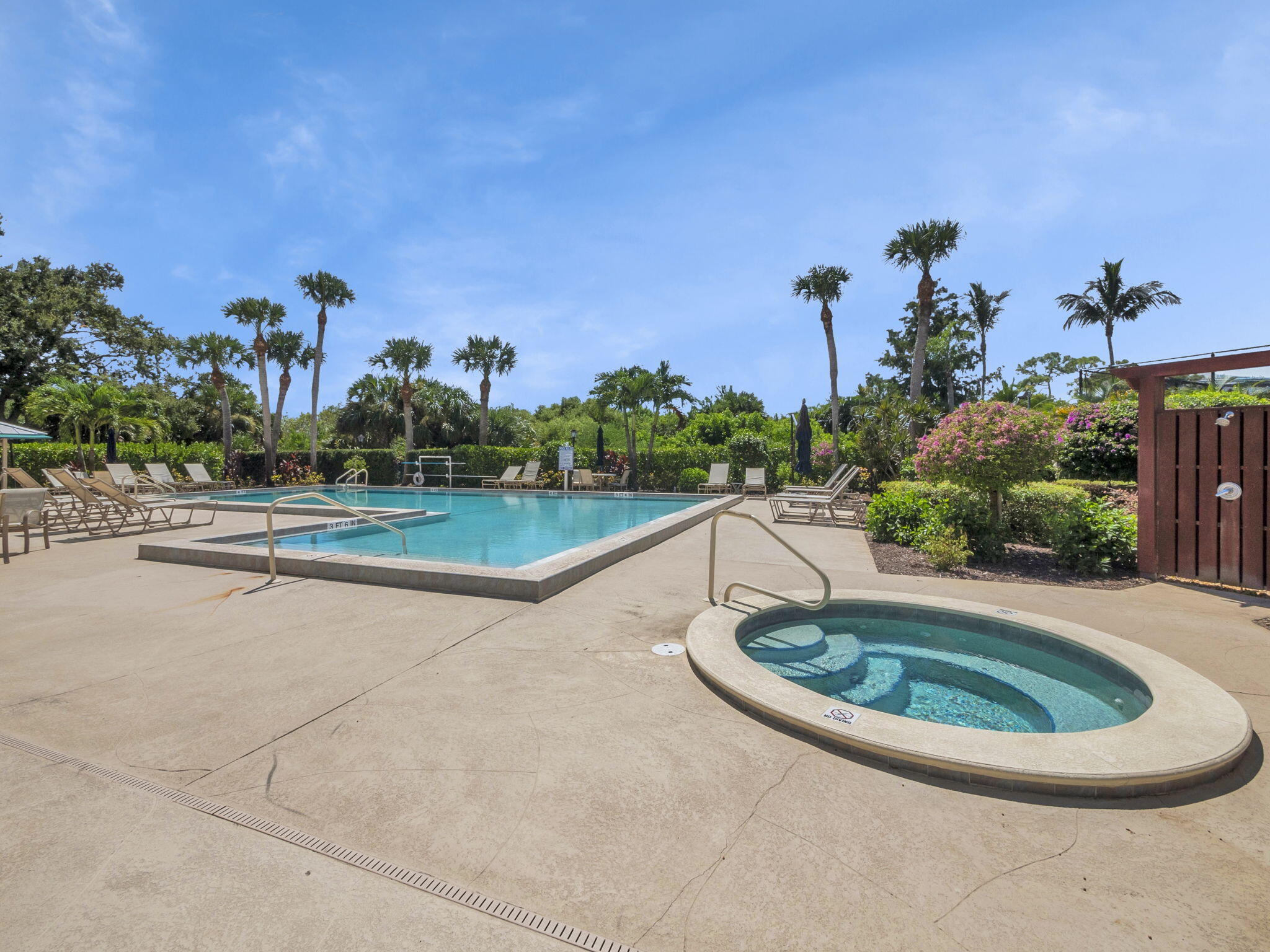 8165 Southeast Cypress Point Place Hobe Sound, FL 33455 - Photo 39 of 46 a swimming pool with outdoor seating and plants
