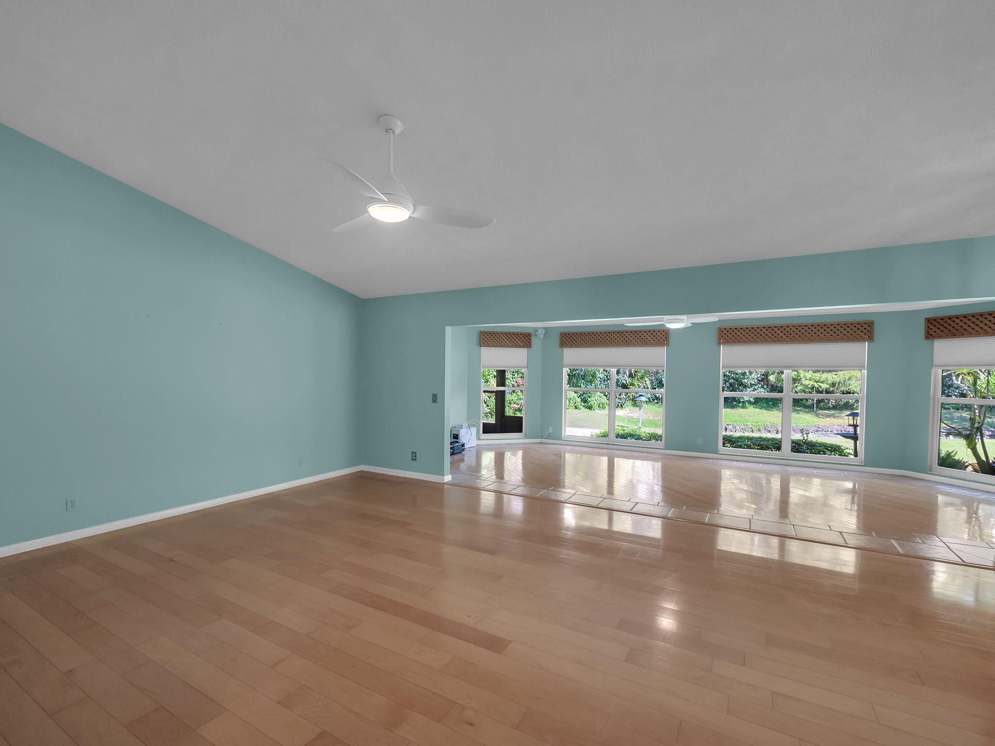 8165 Southeast Cypress Point Place Hobe Sound, FL 33455 - Photo 4 of 46 a view of empty room with wooden floor and fan