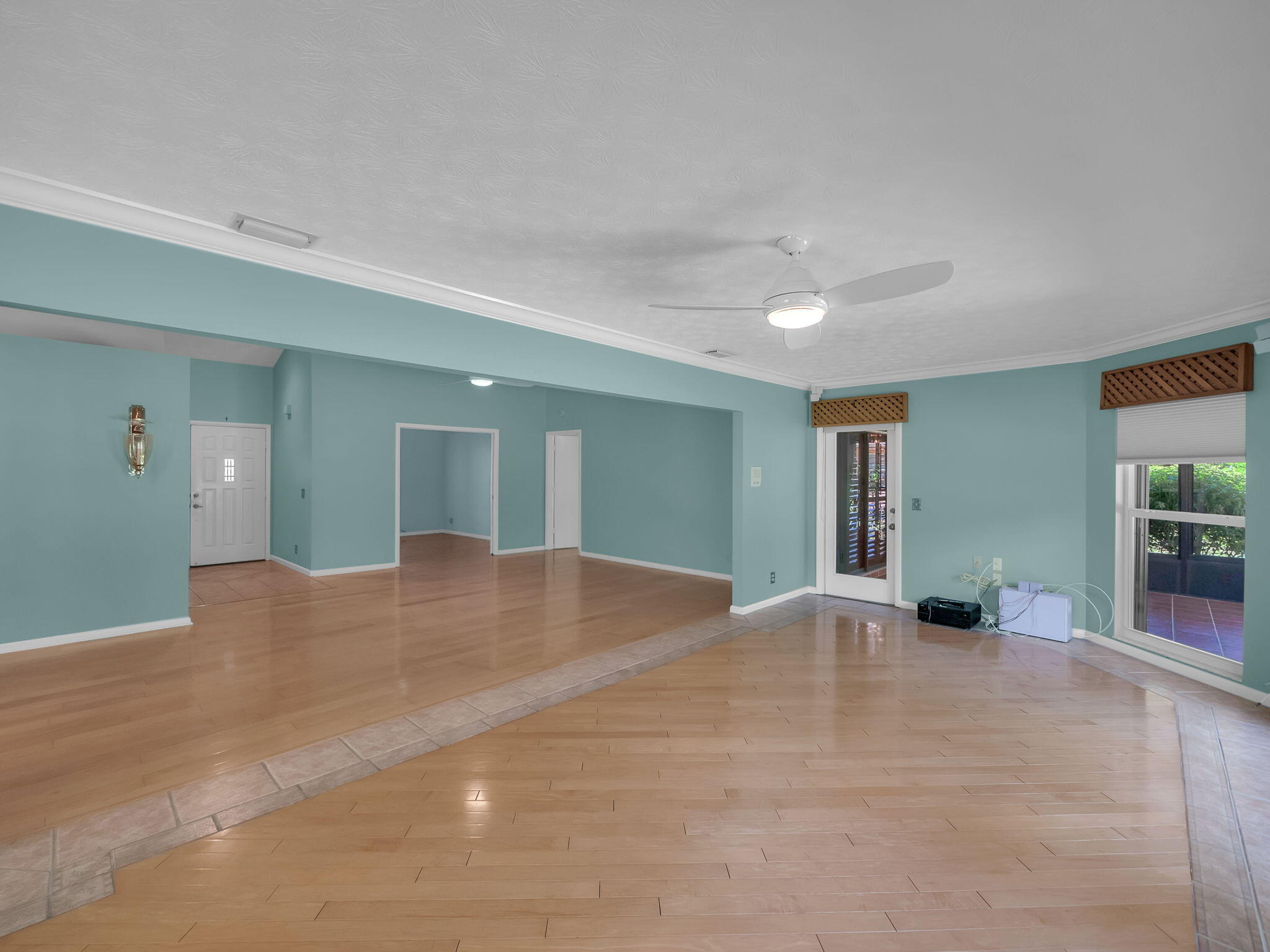 8165 Southeast Cypress Point Place Hobe Sound, FL 33455 - Photo 9 of 46 a view of an empty room with wooden floor and a bathroom