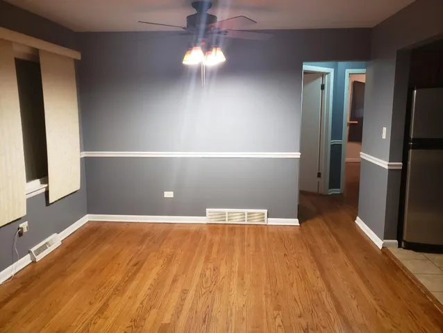a view of a livingroom with a furniture wooden floor and staircase