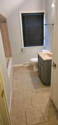 a bathroom with a tub a sink and a mirror