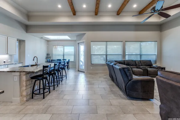 a living room with furniture a window and stainless steel appliances