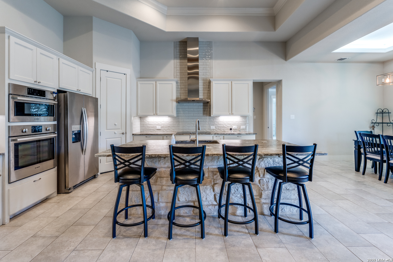 230 Sabella Spring Branch, TX 78070 - Photo 10 of 24 a kitchen with stainless steel appliances kitchen island granite countertop a table chairs and a refrigerator