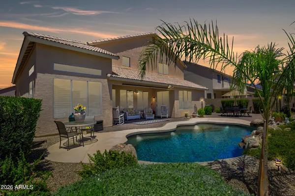 a view of a house with sitting area and swimming pool