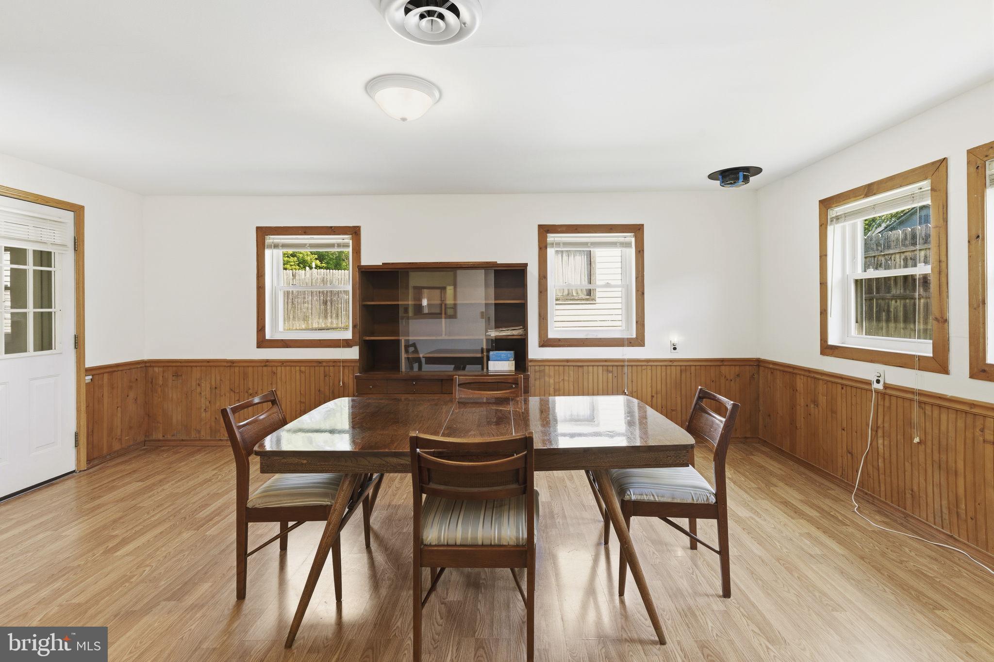 2411 Poplar Road Baltimore, MD 21221 - Photo 21 of 36 a view of a dining room with furniture and wooden floor