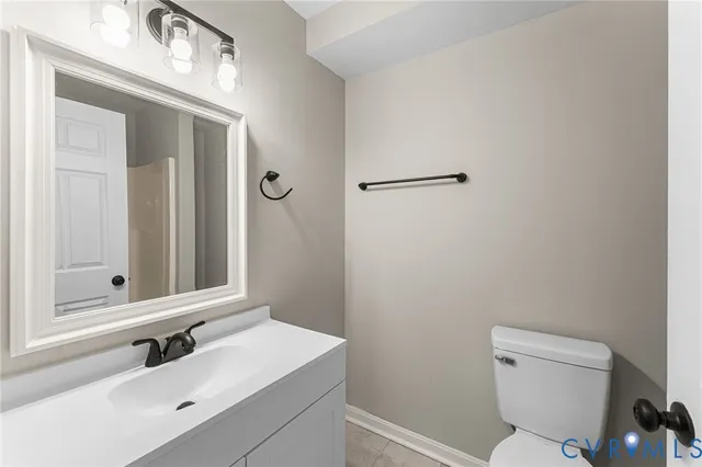 a bathroom with a sink vanity mirror and toilet
