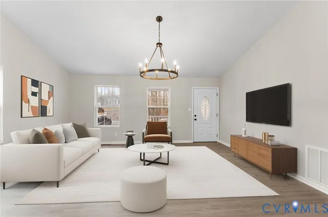 a living room with furniture and a flat screen tv