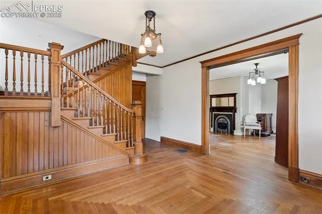 a view of a livingroom with furniture a fireplace and wooden floor