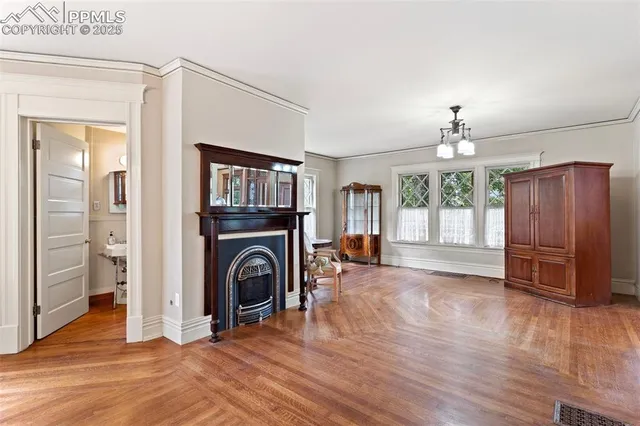 a view of a livingroom with wooden floor and a ceiling fan