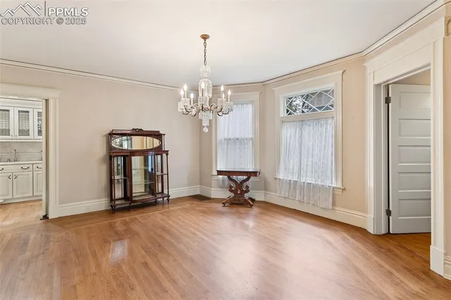 a kitchen with stainless steel appliances a dining table chairs microwave and cabinets