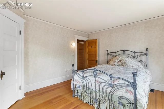 a view of a room with wooden floor and bathroom view