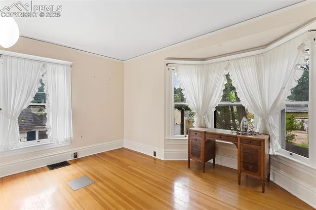 an empty room with windows and entrance