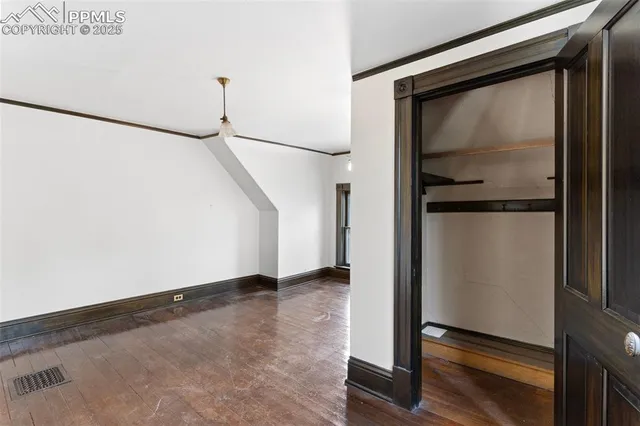 an empty room with wooden floor