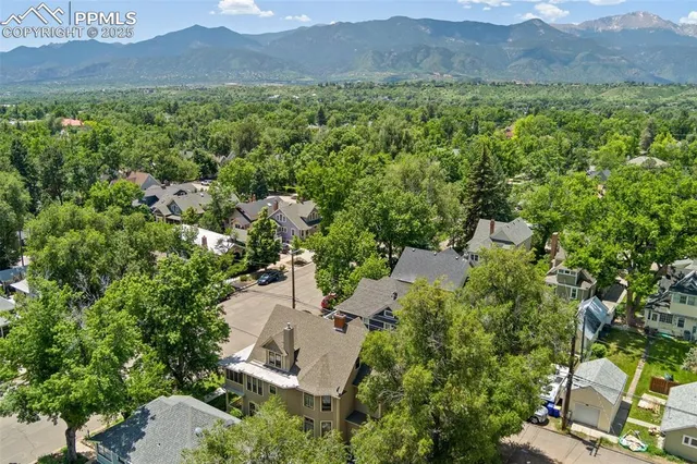 an aerial view of a house with outdoor space and garden