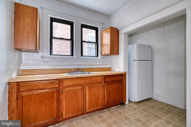 a view of kitchen with granite countertop cabinets and window