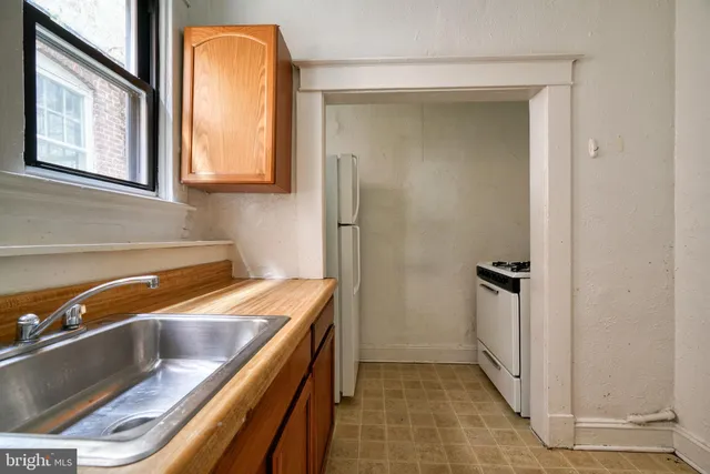 a kitchen with a refrigerator and a sink