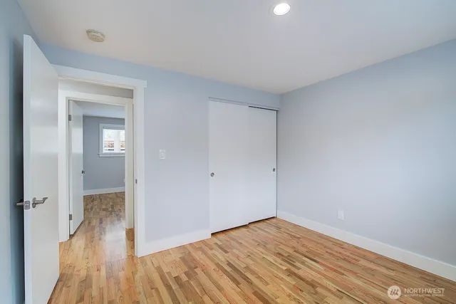 a view of an empty room and wooden floor