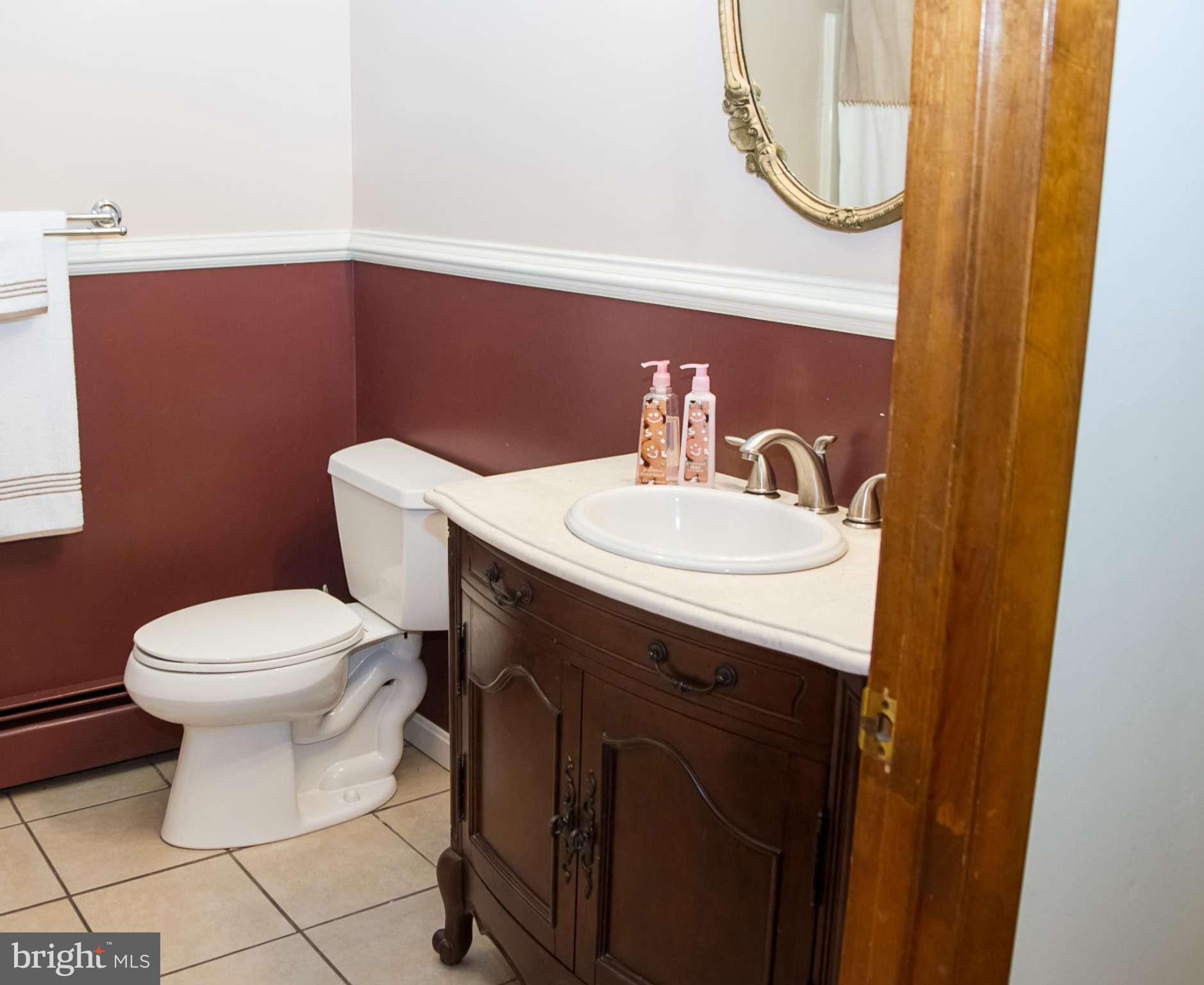 5249 Carroll Warehime Road Manchester, MD 21102 - Photo 17 of 26 a bathroom with a sink a toilet and a mirror