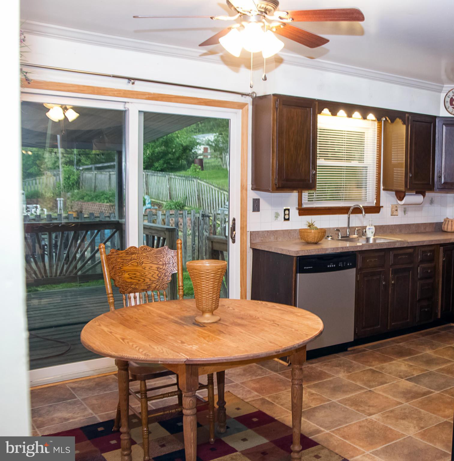5249 Carroll Warehime Road Manchester, MD 21102 - Photo 20 of 26 a kitchen with a stove a sink a table and chairs