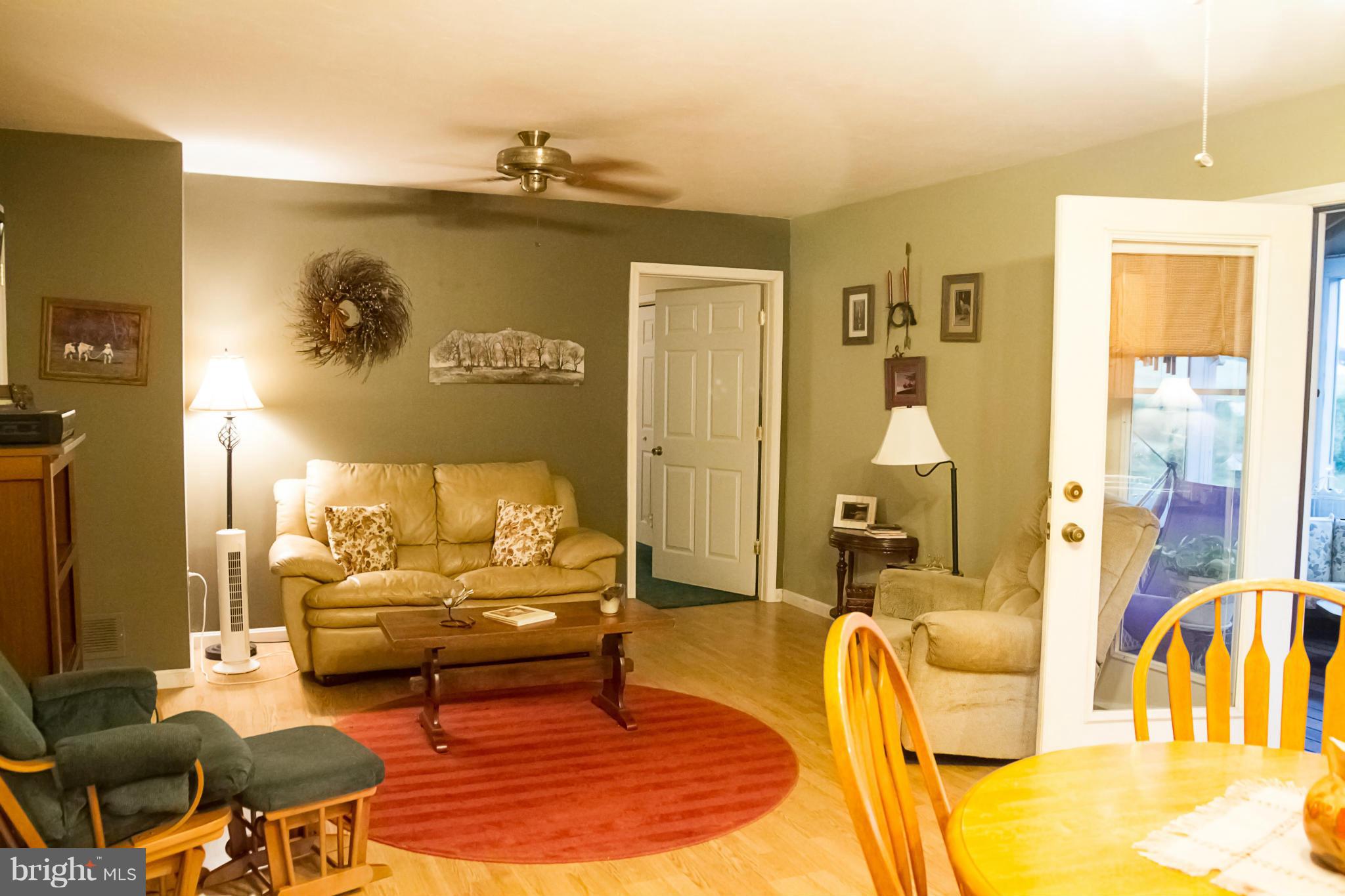 5249 Carroll Warehime Road Manchester, MD 21102 - Photo 9 of 26 a living room with furniture and a chandelier