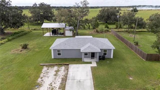 a aerial view of a house with swimming pool garden and patio