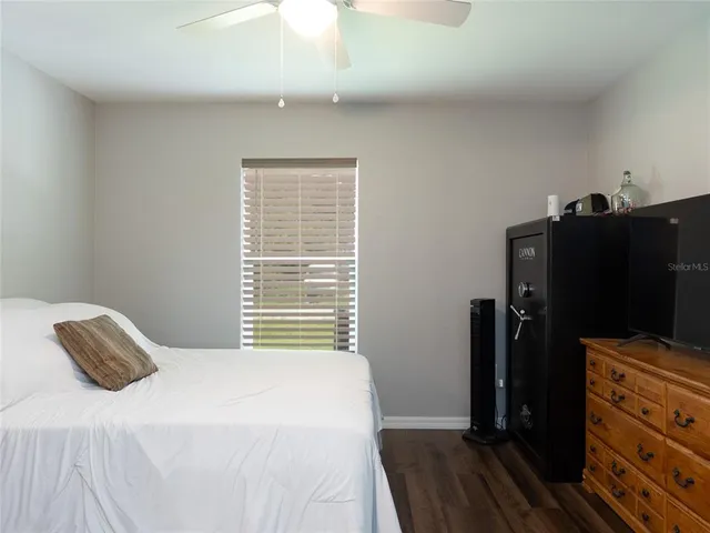 a bedroom with a bed and a flat tv screen