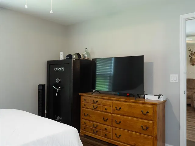 a bedroom with a bed and television