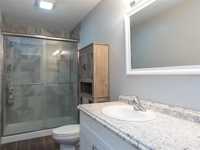 a bathroom with a sink toilet and shower
