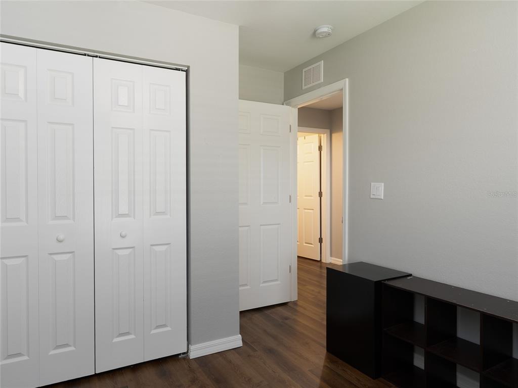 1833 Southeast Tangelo Drive Arcadia, FL 34266 - Photo 20 of 38 an empty room with wooden floor and closet