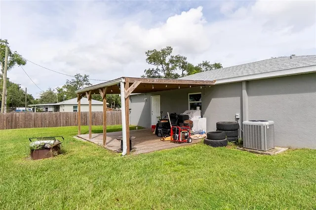 a view of a backyard with a slide and a wooden deck