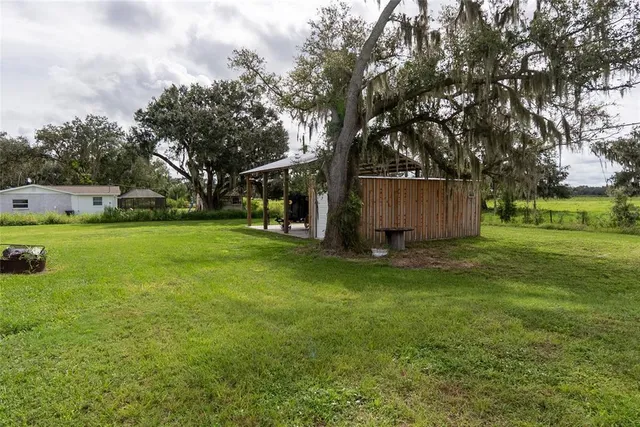 a view of a backyard with large trees