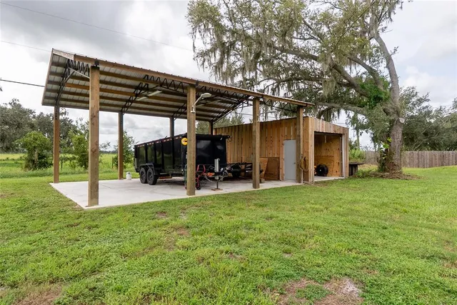 a view of a house with backyard porch and sitting area